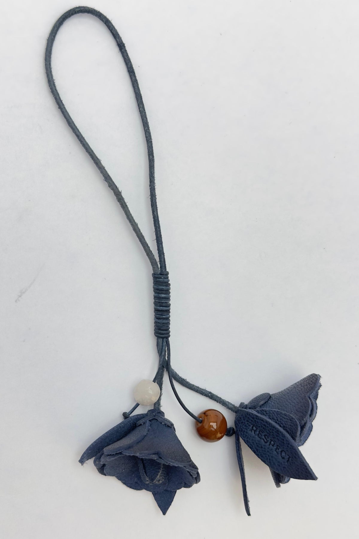 Signature Flower in Cobalt leather — front view